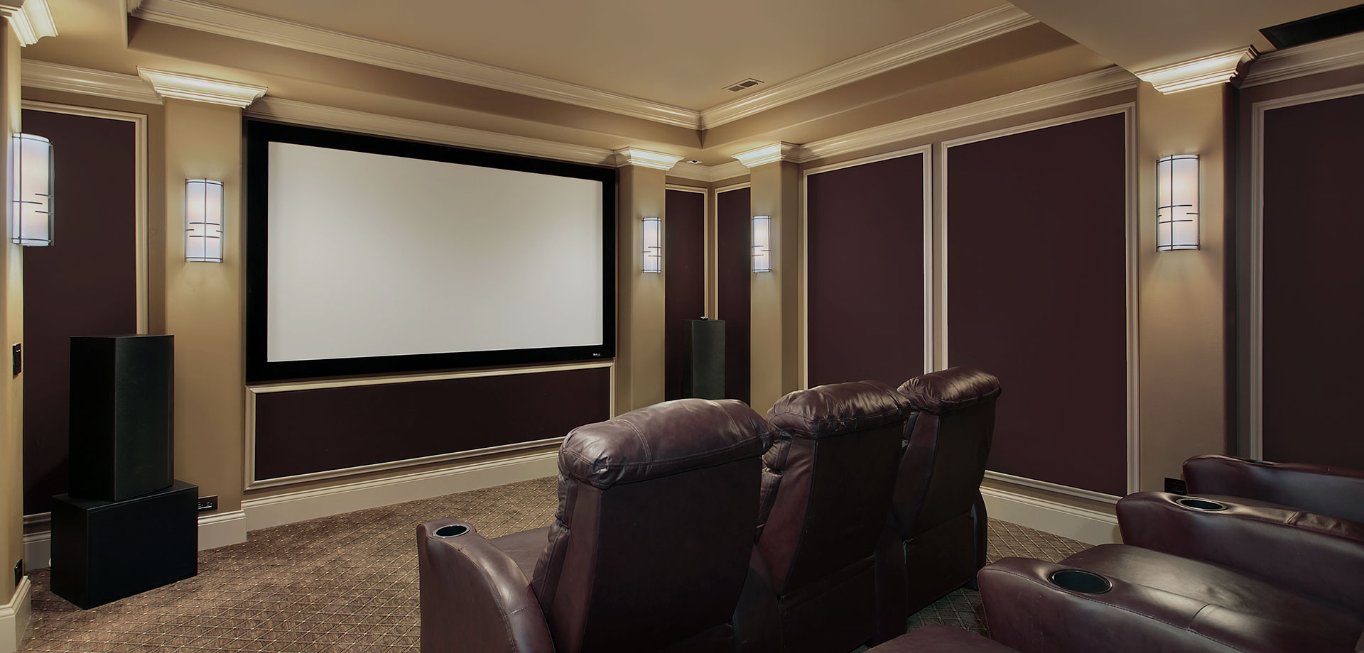Home Theater set up with audio visual equipment and burgundy recliners